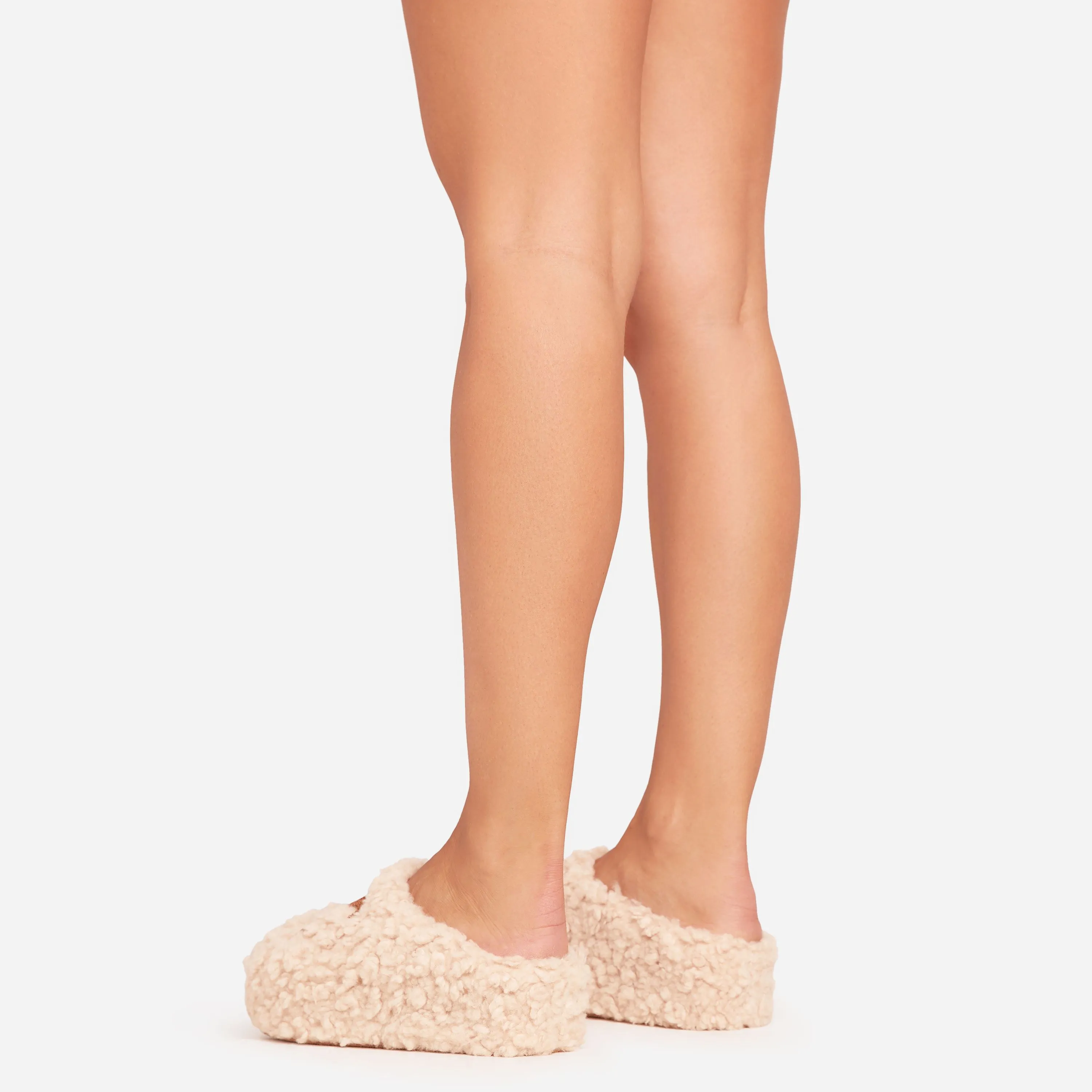 Saskia Logo Detail Flat Slipper In Nude Faux Fur